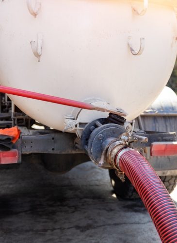 Close-up,Pipe,Hose,Of,Sewage,Truck,Car,Engine,Emptying,Home