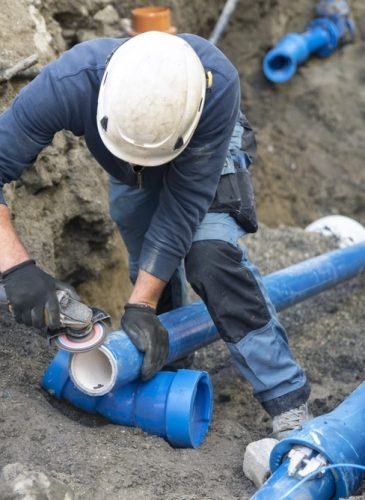 Workers,Install,Underground,Pipes,For,Water,,Sewerage,,Electricity,And,Fiber